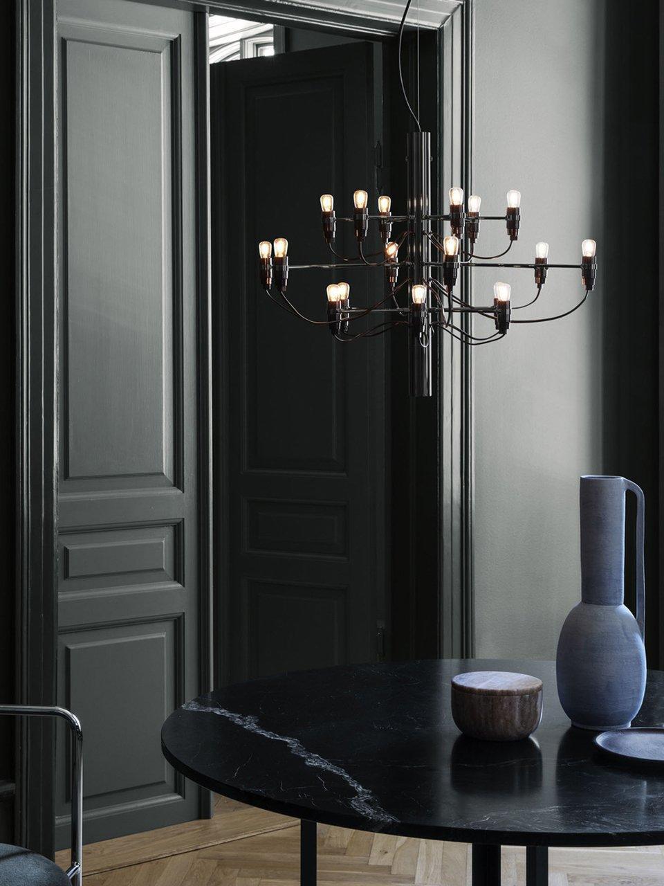 Exposed bulbs and radial arms near dark wall panelling