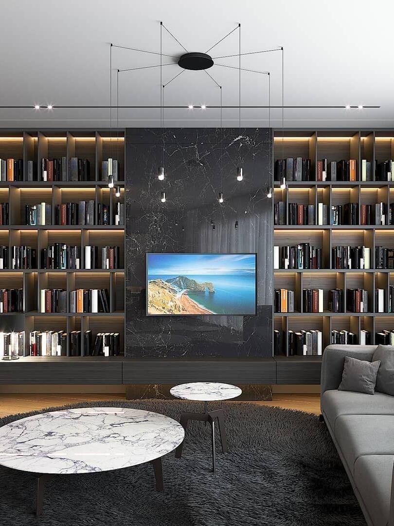 Small pendant heads around a central ceiling plate in a room with bookshelves and television