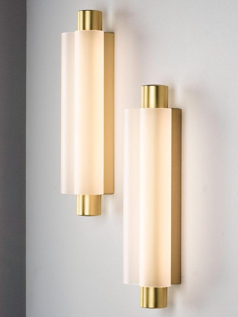 Two gold-tone Metropol wall fixtures at staggered heights