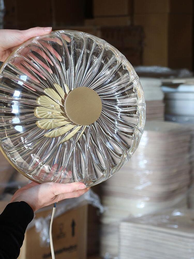 Ribbed glass dome and central cap held for close view