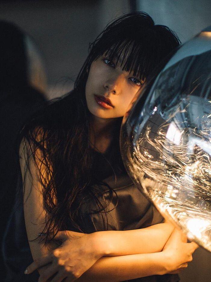 Person beside an illuminated reflective shade