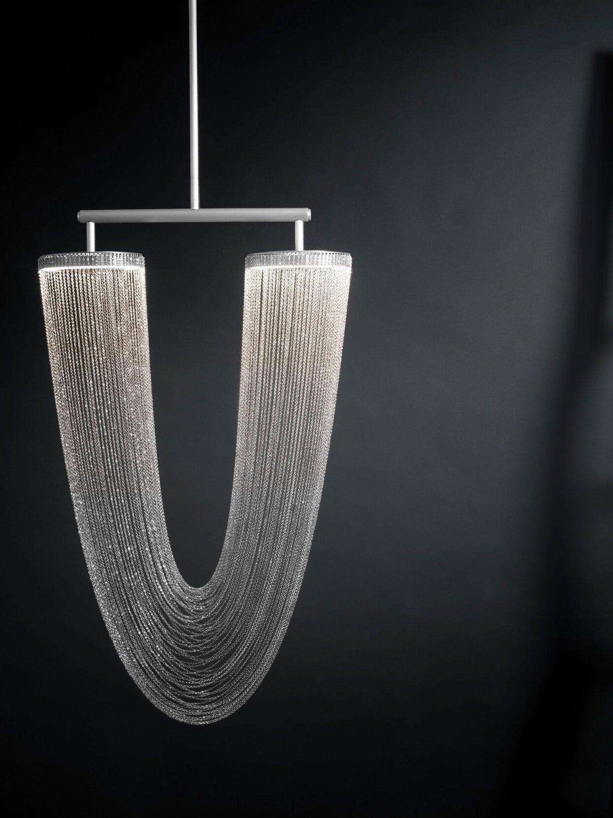 Pale metallic chain fixture on a dark background