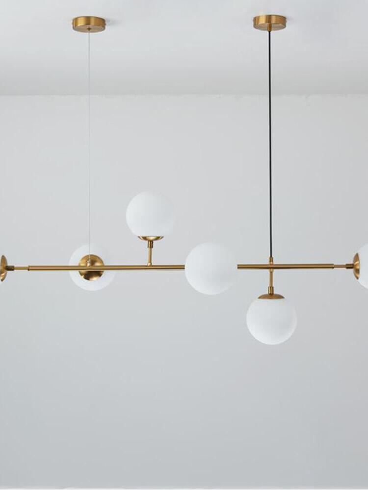 White globes and brass-coloured frame close view