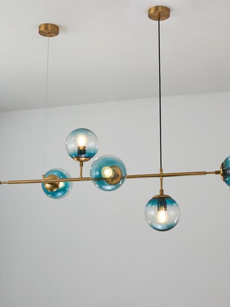 Blue-green glass globes on a brass-coloured bar
