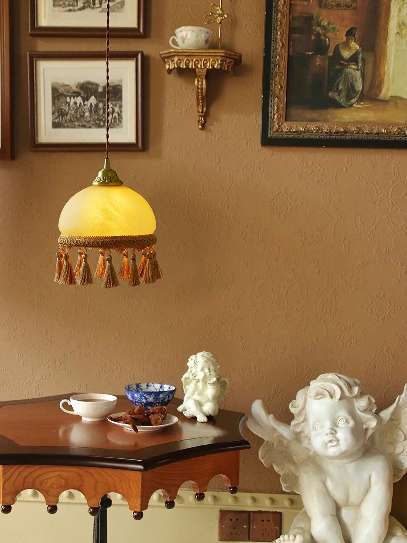 Yellow tassel pendant above vintage tea table