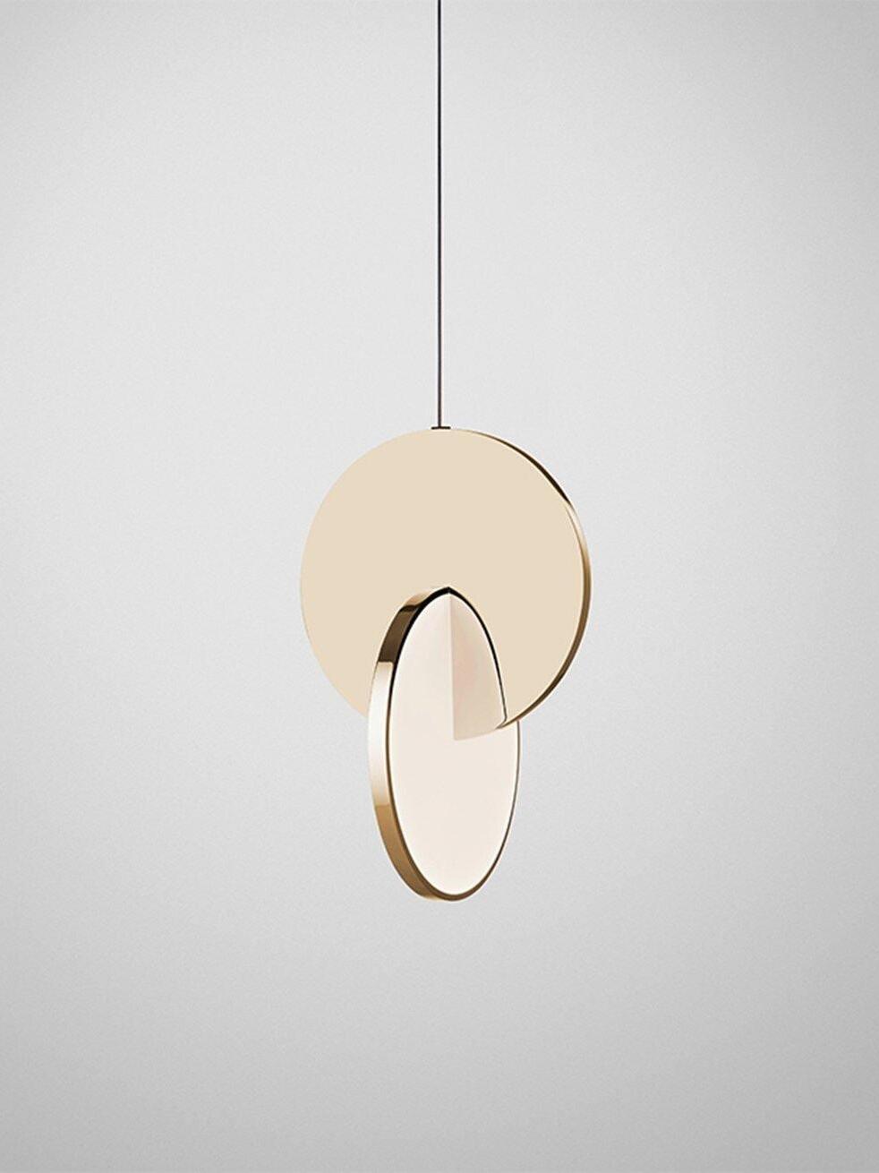 Single gold disc pendant light with intersecting white diffuser and black cord against grey