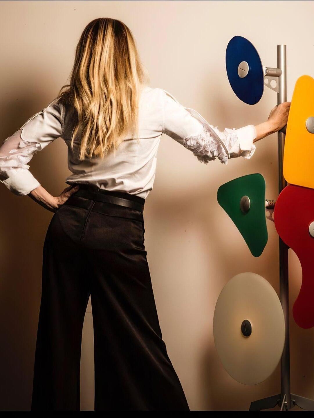 Person beside a panel floor lamp for visual scale