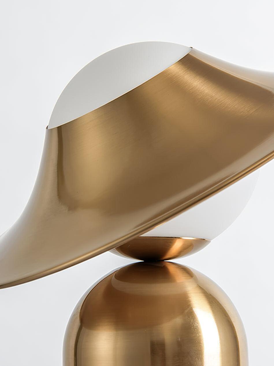 Close angled gold disc over white glass sphere