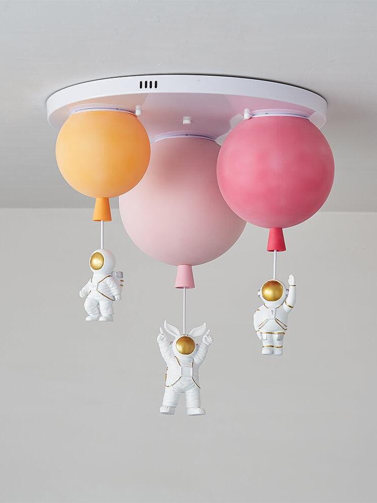 Orange pink and red balloon shades with three astronauts