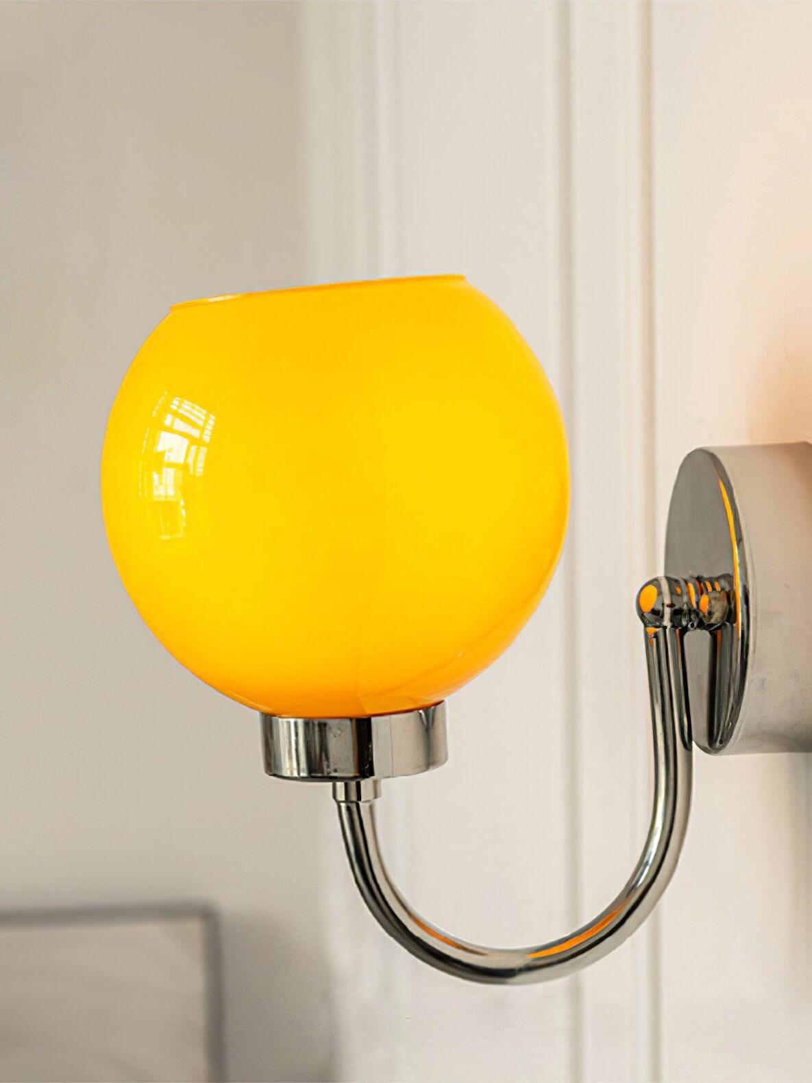 Orange globe above U-shaped silver-tone arm near doorway or window
