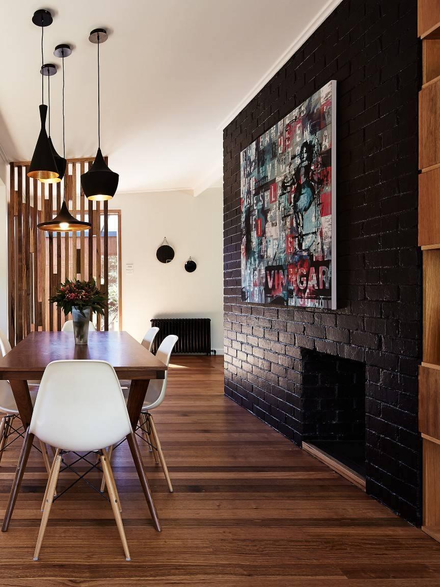 Black pendant group above a table by a dark wall