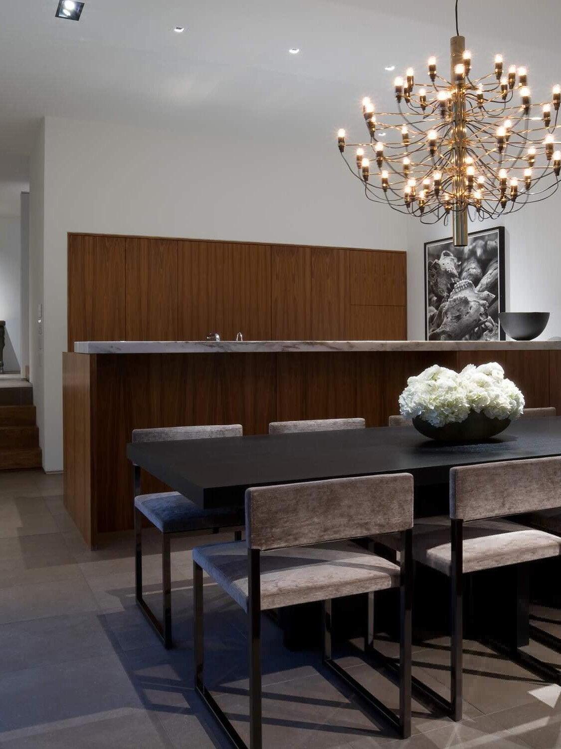 Large tiered chandelier above dining furniture