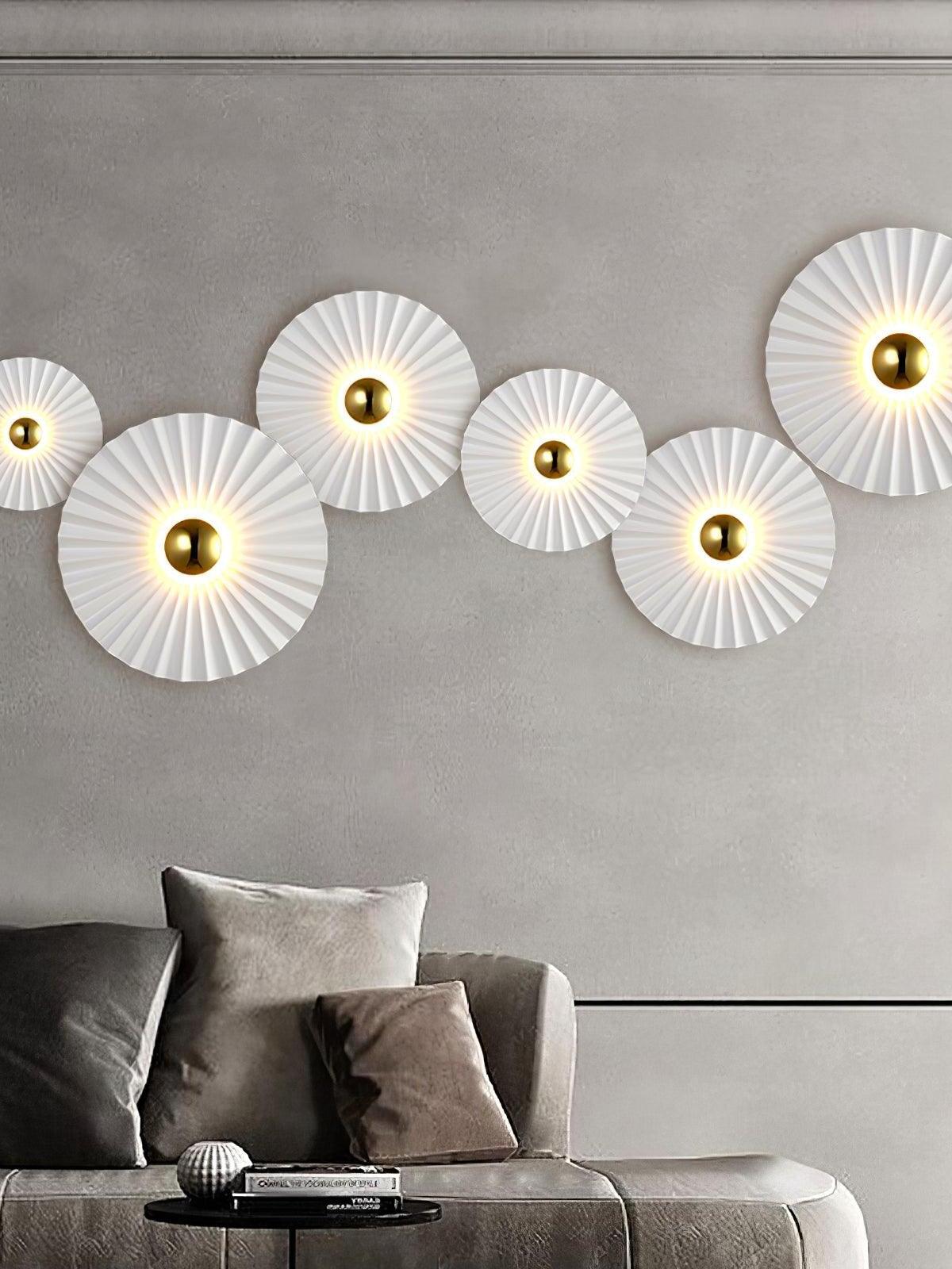 Five white radial wall lights over grey sofa