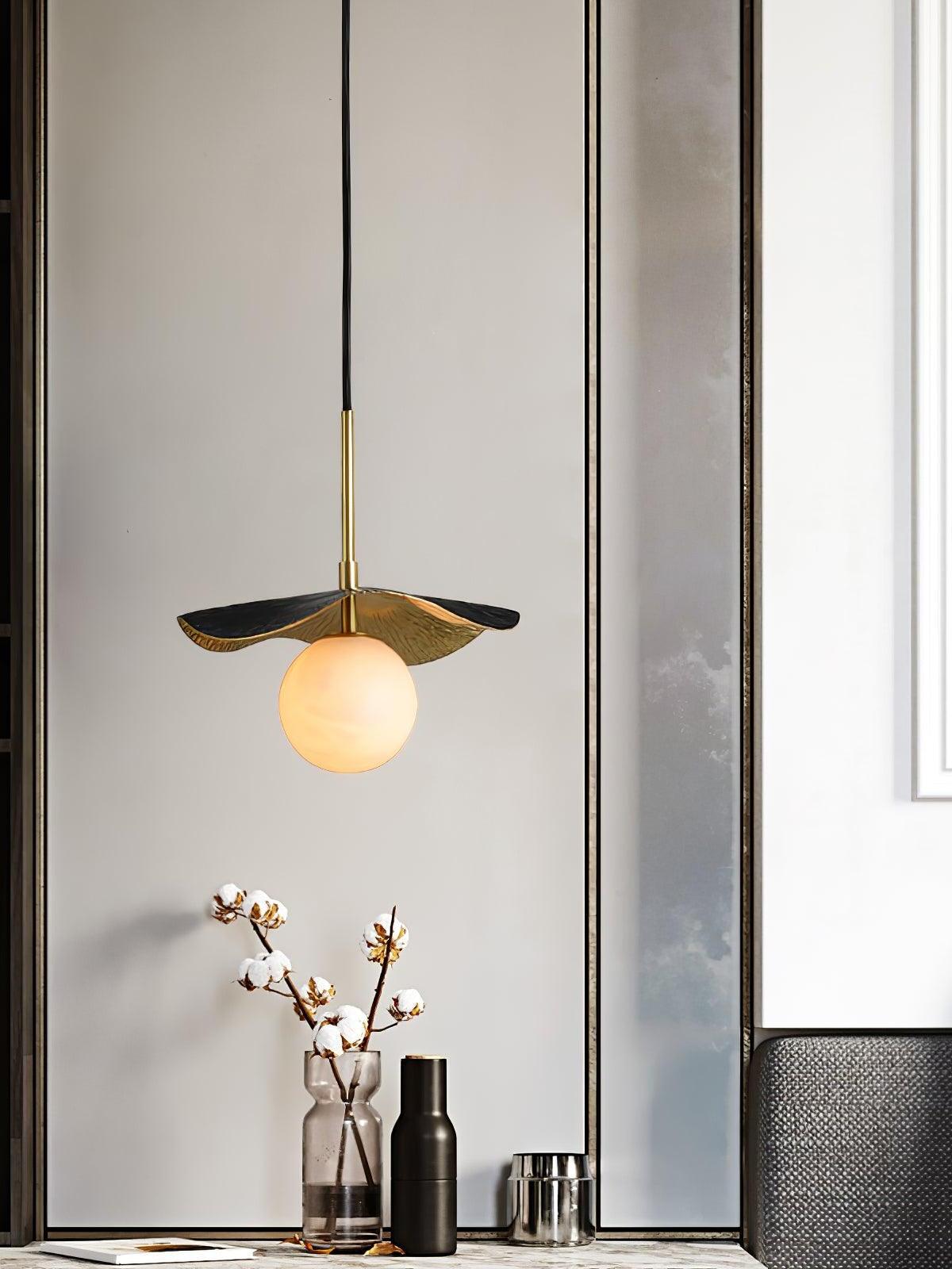 Montera globe pendant above floral sideboard