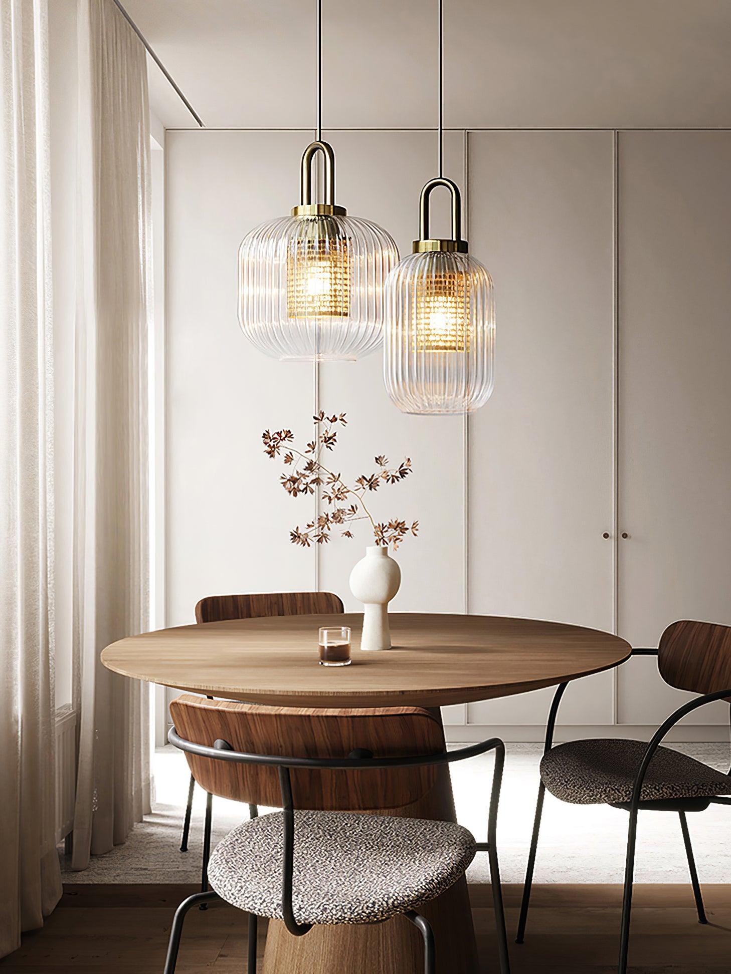 Ribbed-glass pendants above a round wooden table