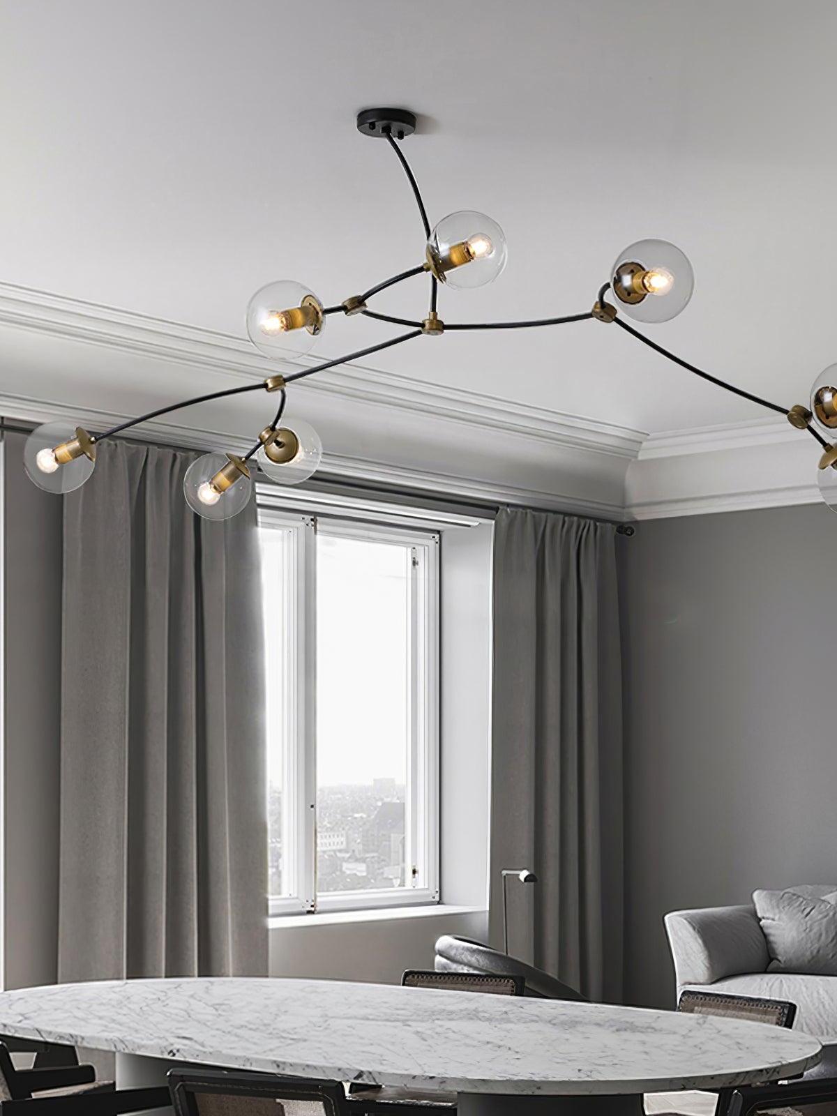 Clear globe chandelier in a dining room with tall curtains