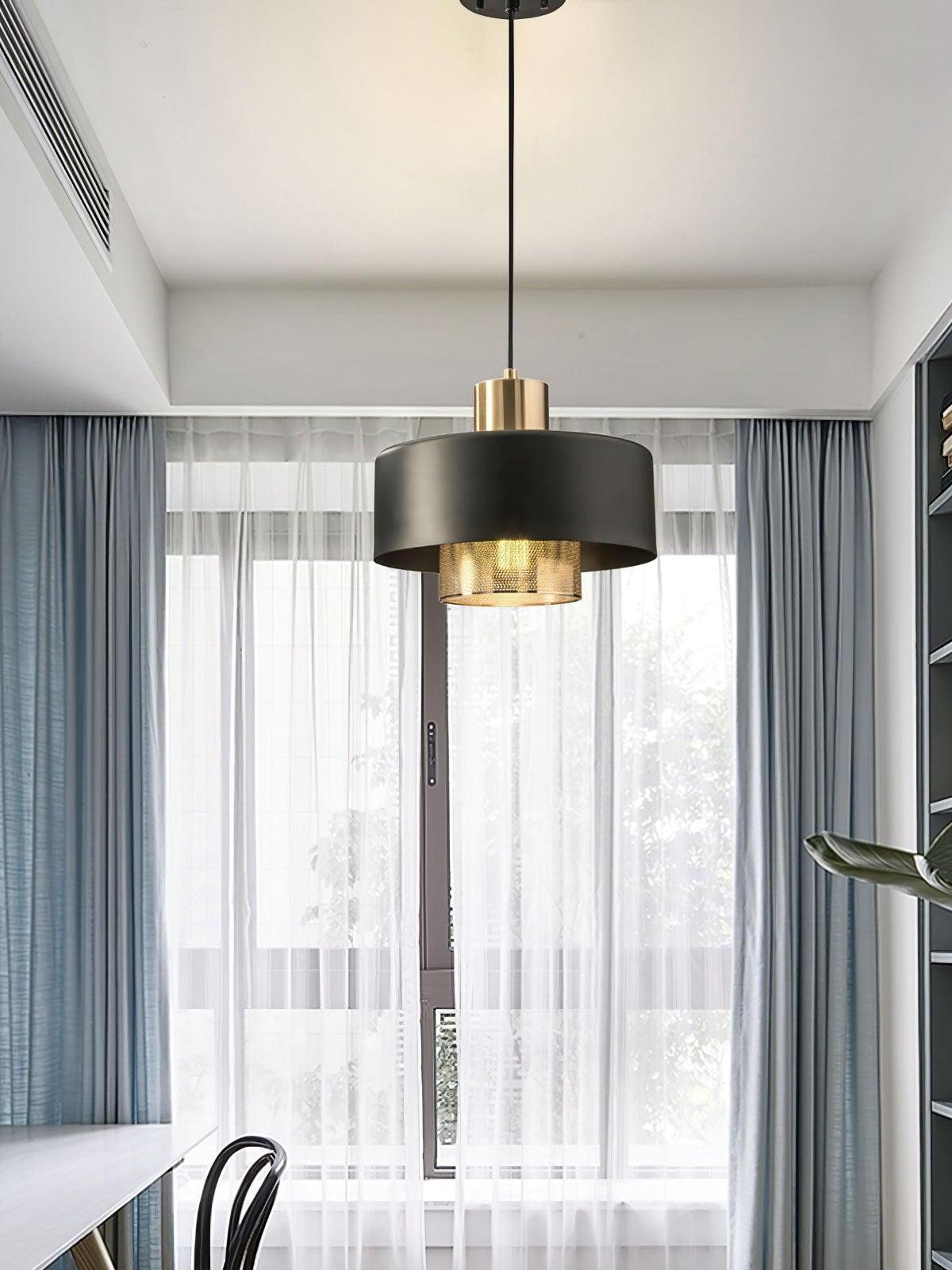 Bradbury pendant hanging near a curtained window above a table and black chair
