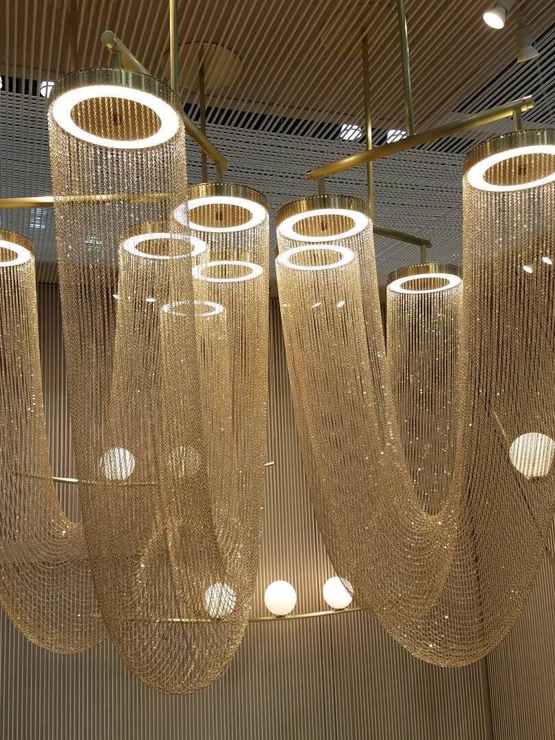 Illuminated rings and draped chains in a showroom close-up