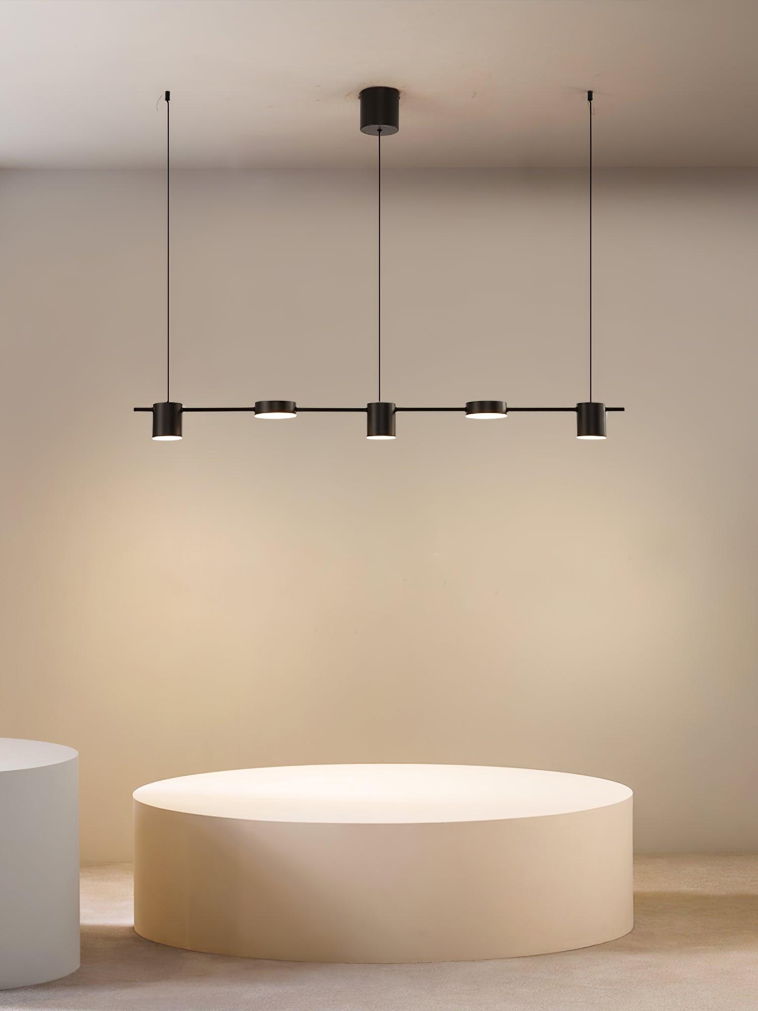 Black linear pendant above a white freestanding bath in a room scene