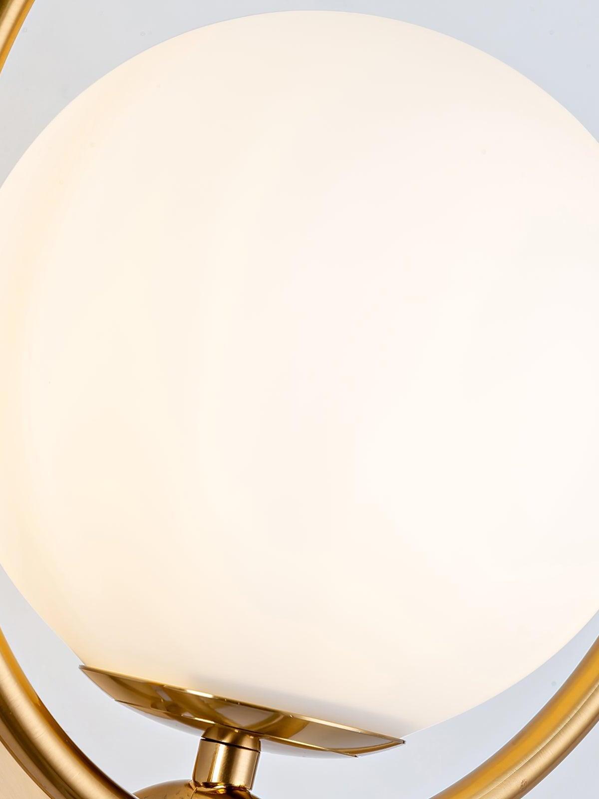 Close view of white glass globe within gold ring