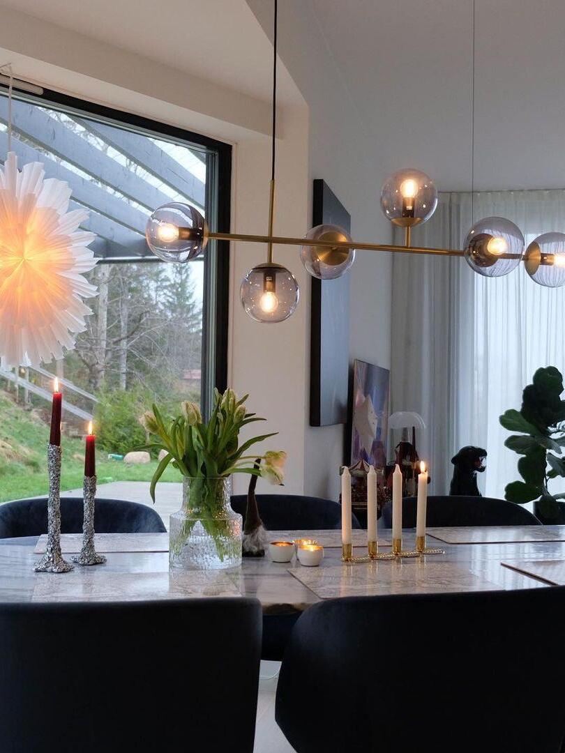 Linear glass chandelier near a kitchen window