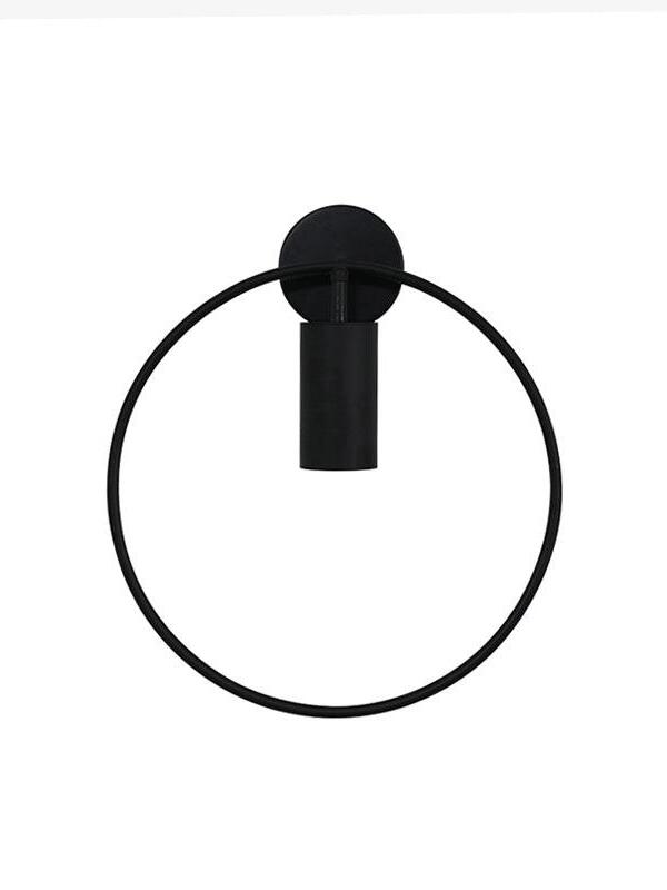 Front view of the black Revolta circular-frame wall lamp and downward cylinder.