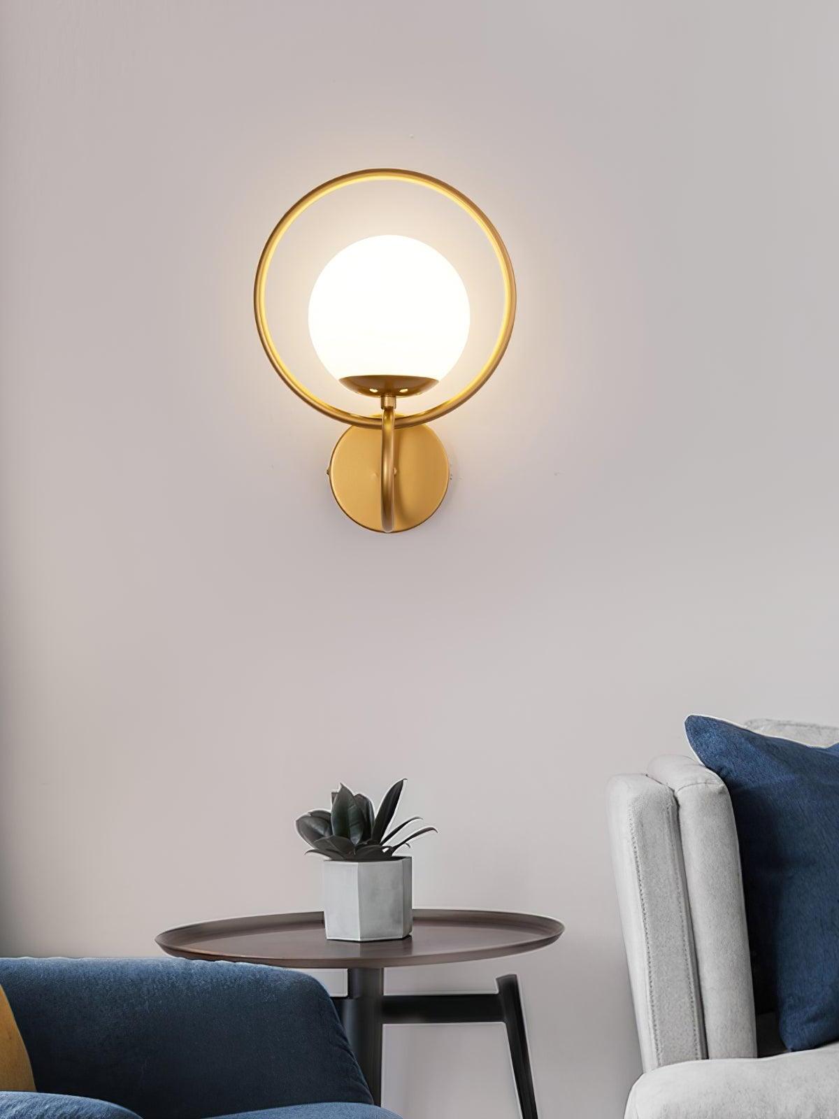 Gold ring glass globe light above side table