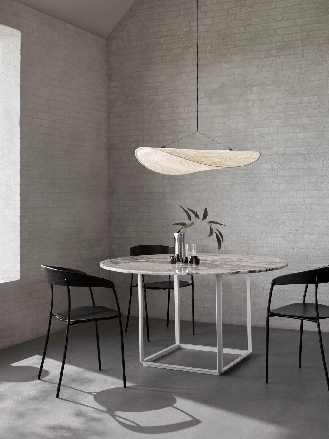 Single white pendant over a round dining table