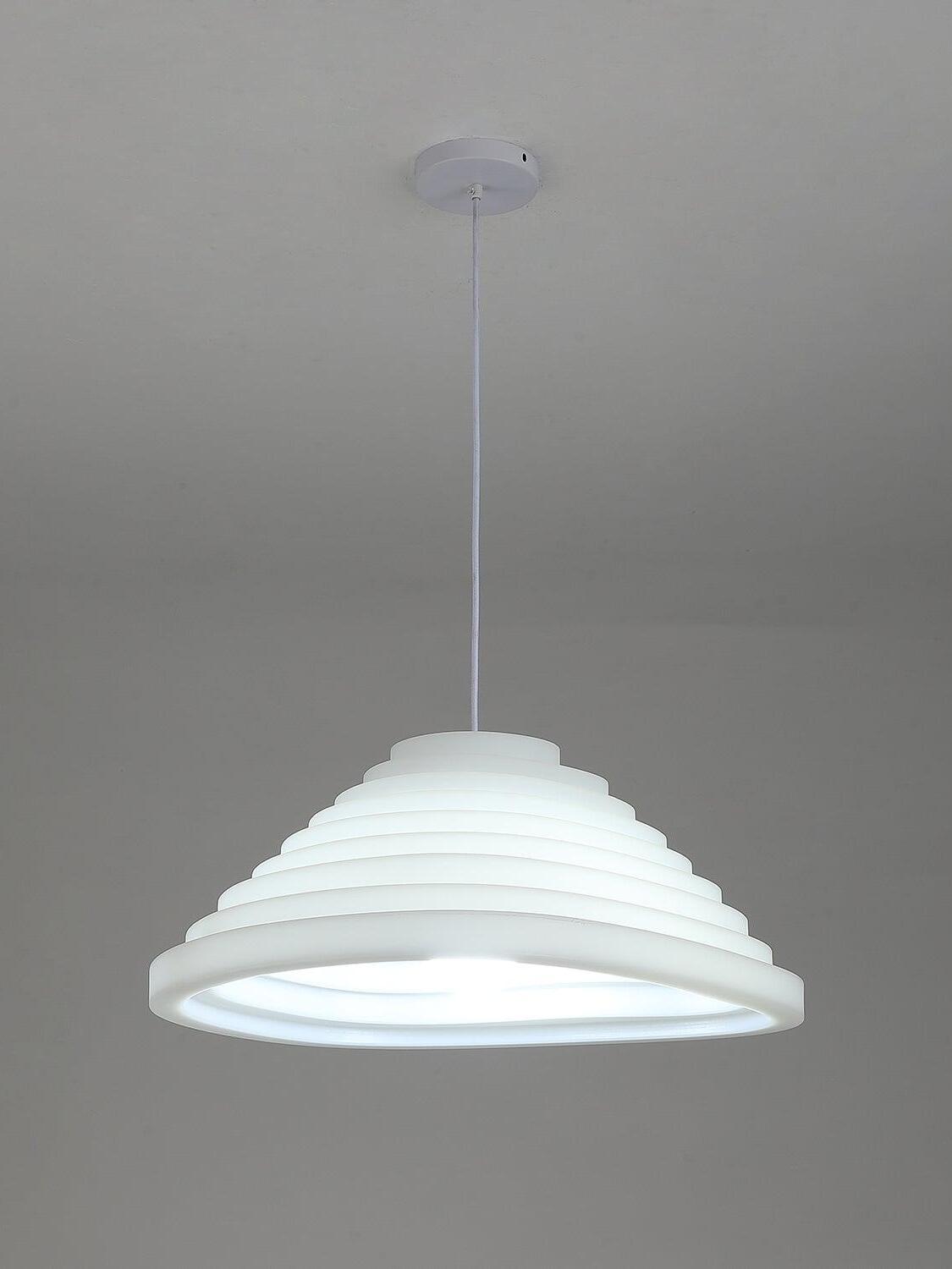 Round stepped pendant illuminated with a cool-looking glow on a single suspension cable.