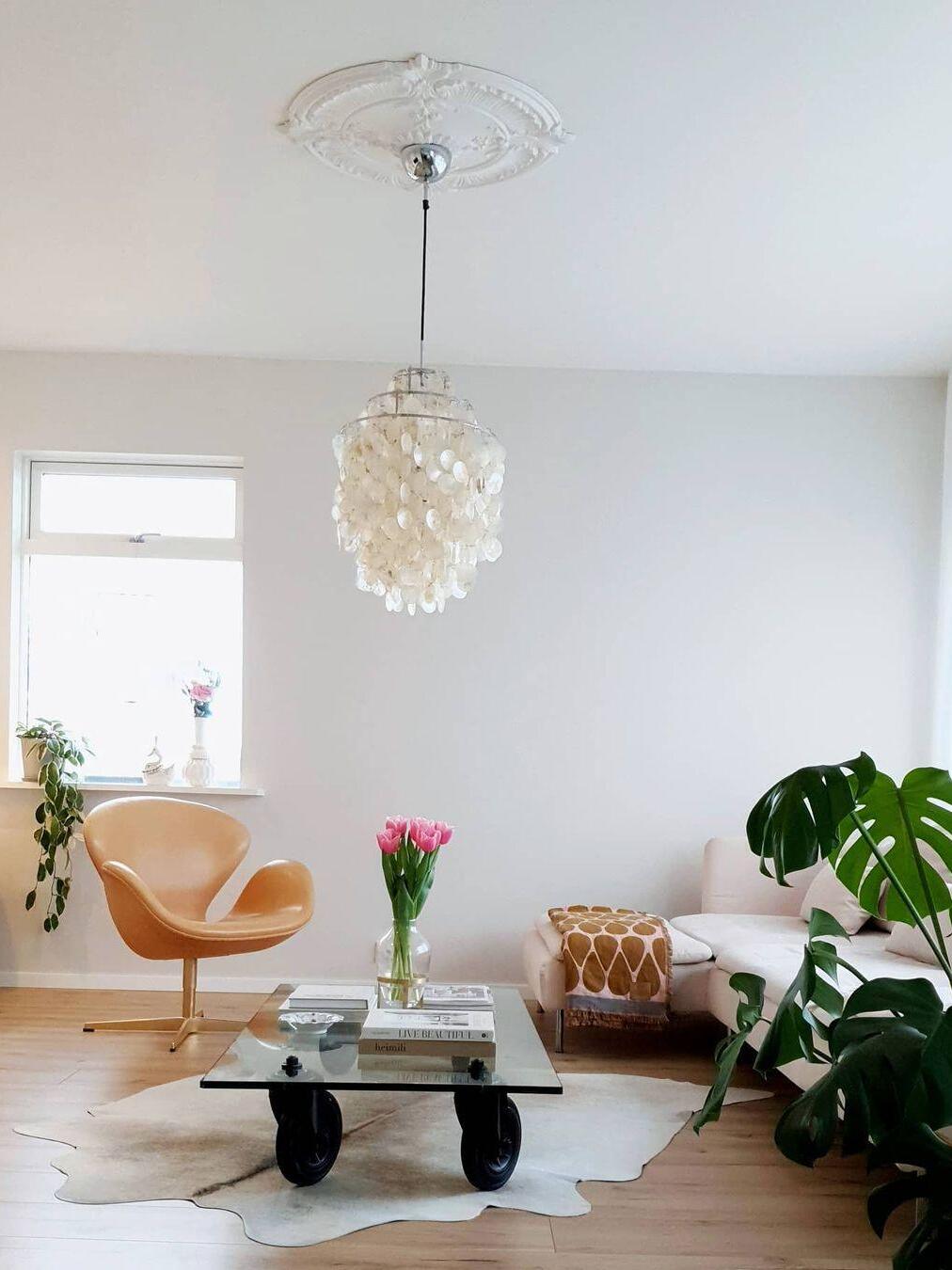 Tall shell chandelier in a white living room