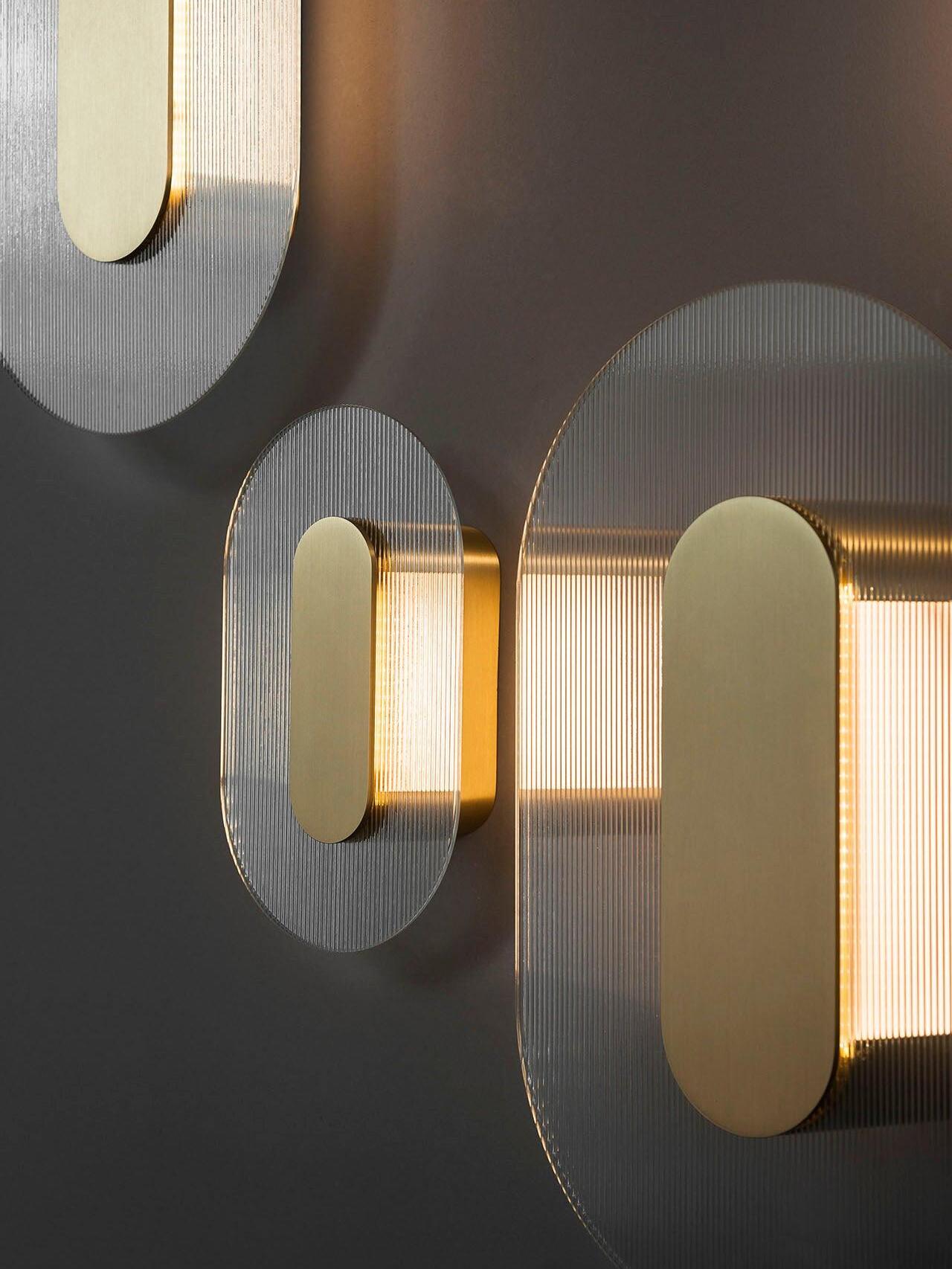 Oblique detail of elongated Button shades with ribbed glass, gold-coloured pill centres and rear housings