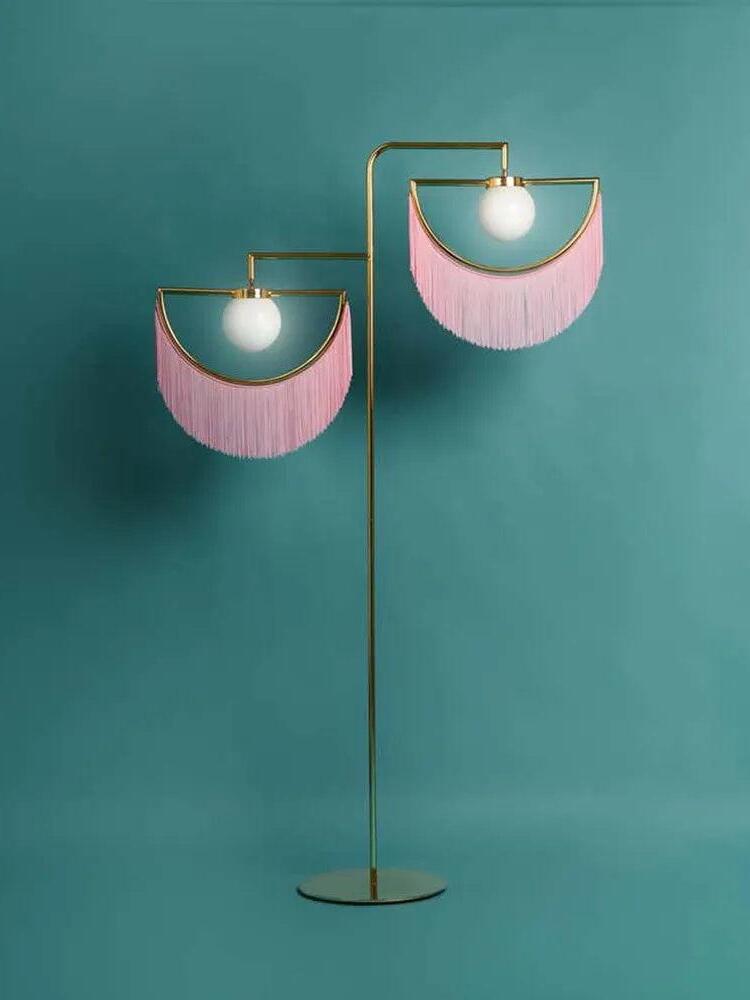Wink pink fringe floor lamp against a teal wall