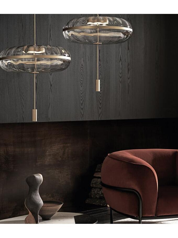 Two glass dome pendants near an armchair