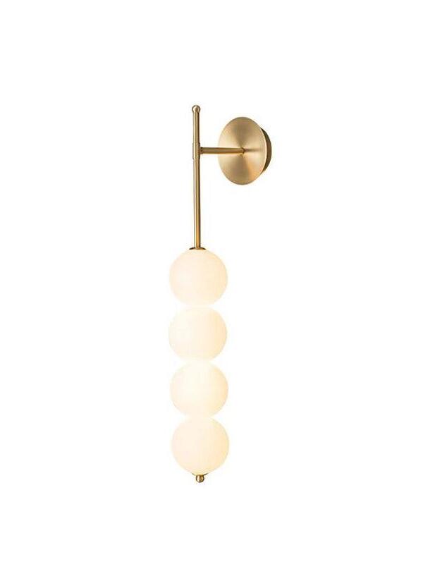 Brass-finish wall lamp with a narrow vertical stem, round wall plate and four white globe shades