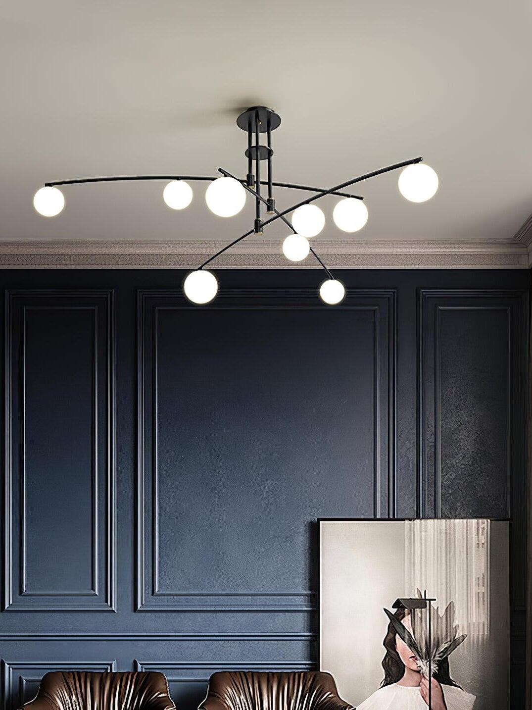 Black chandelier against a dark panelled wall