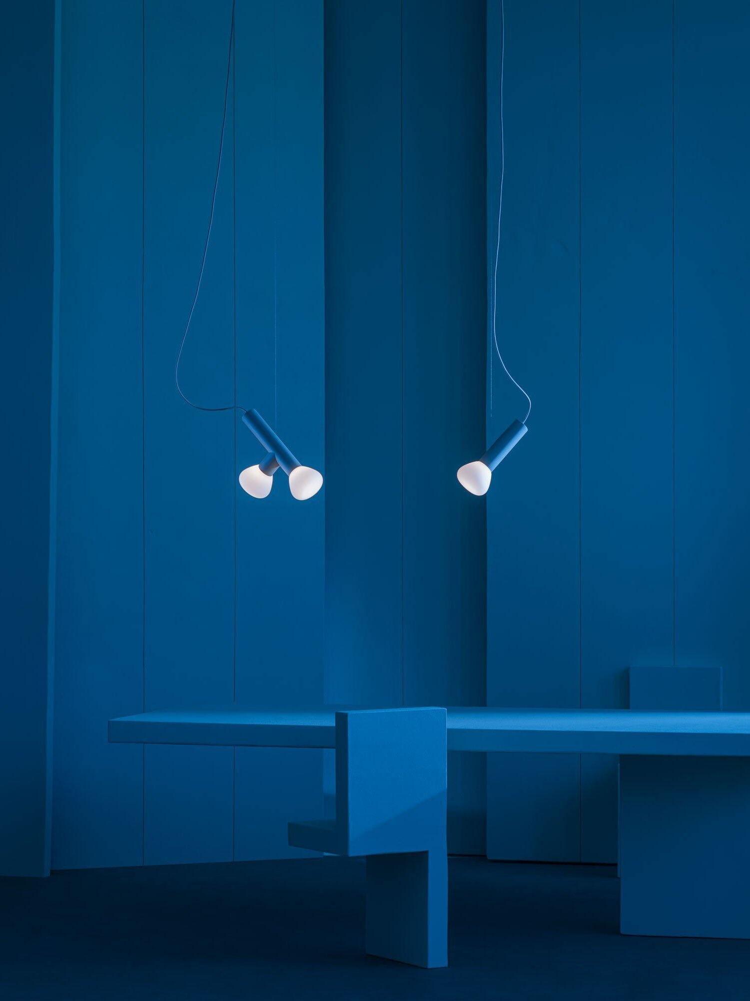 Small white-ended pendants in a blue interior display