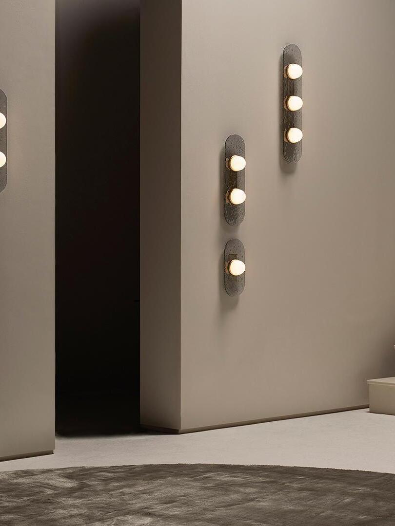 Two- and three-light Modulo wall lights arranged at different heights beside a stair landing