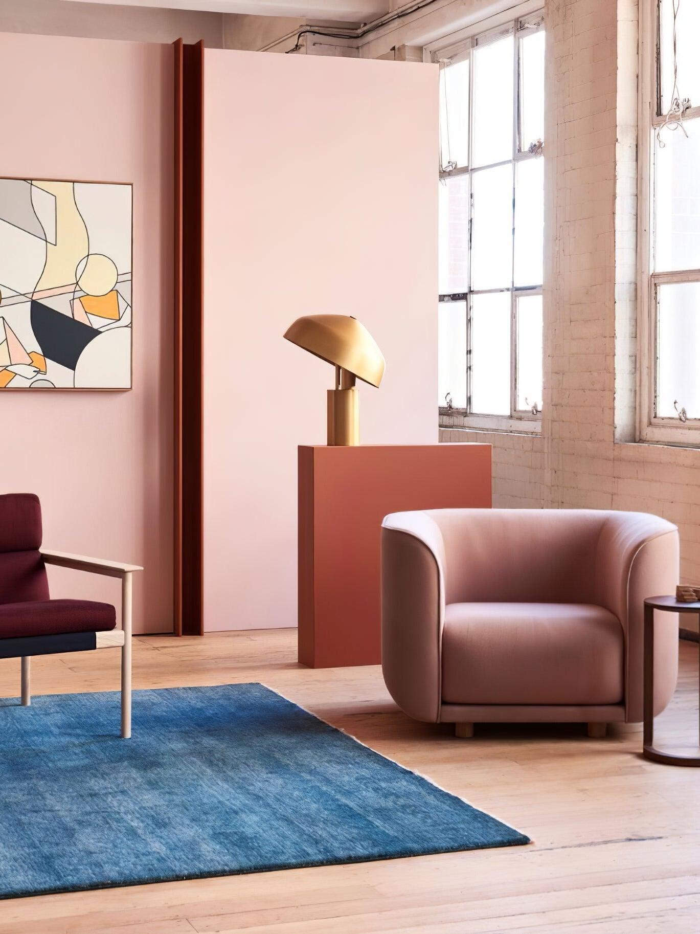 Gold dome table lamp beside pink armchair