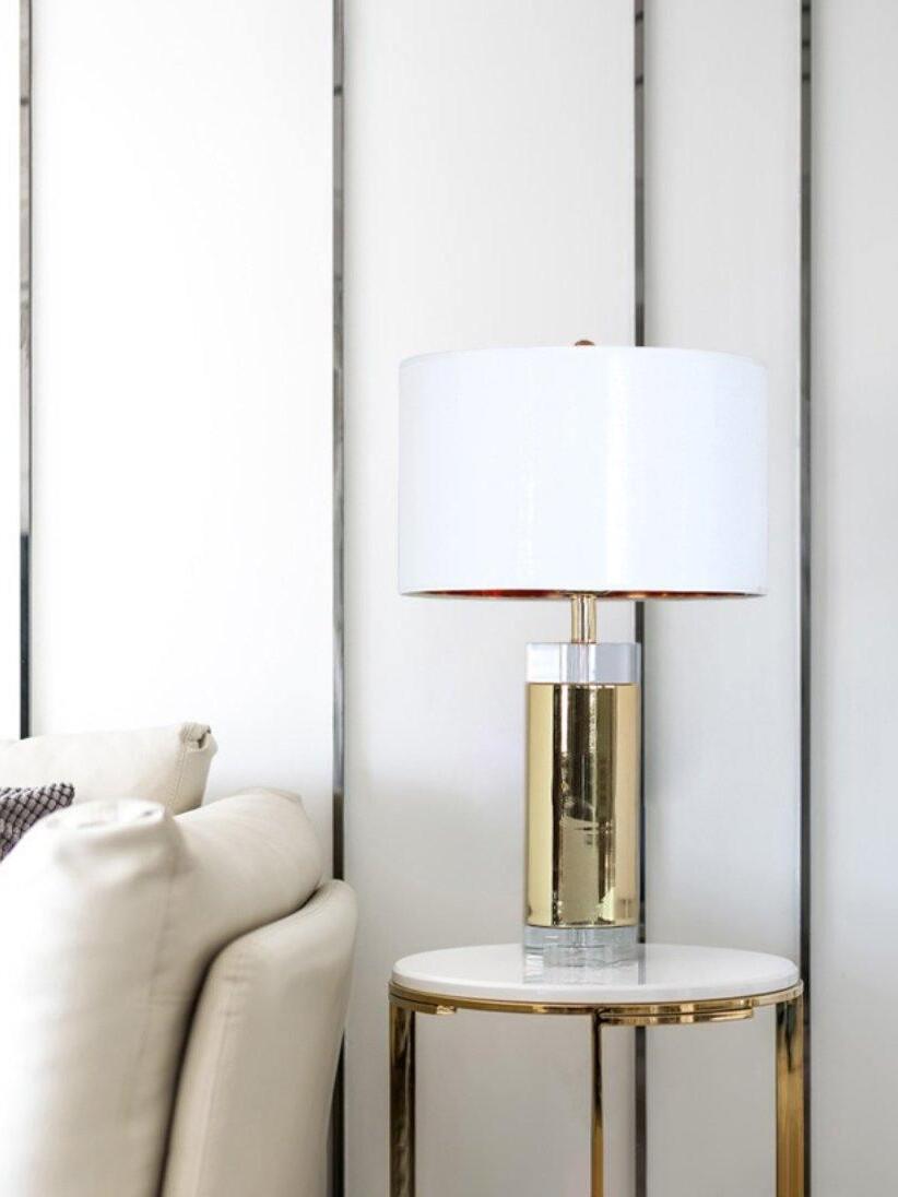 White-shade reflective lamp on round table beside seating and window