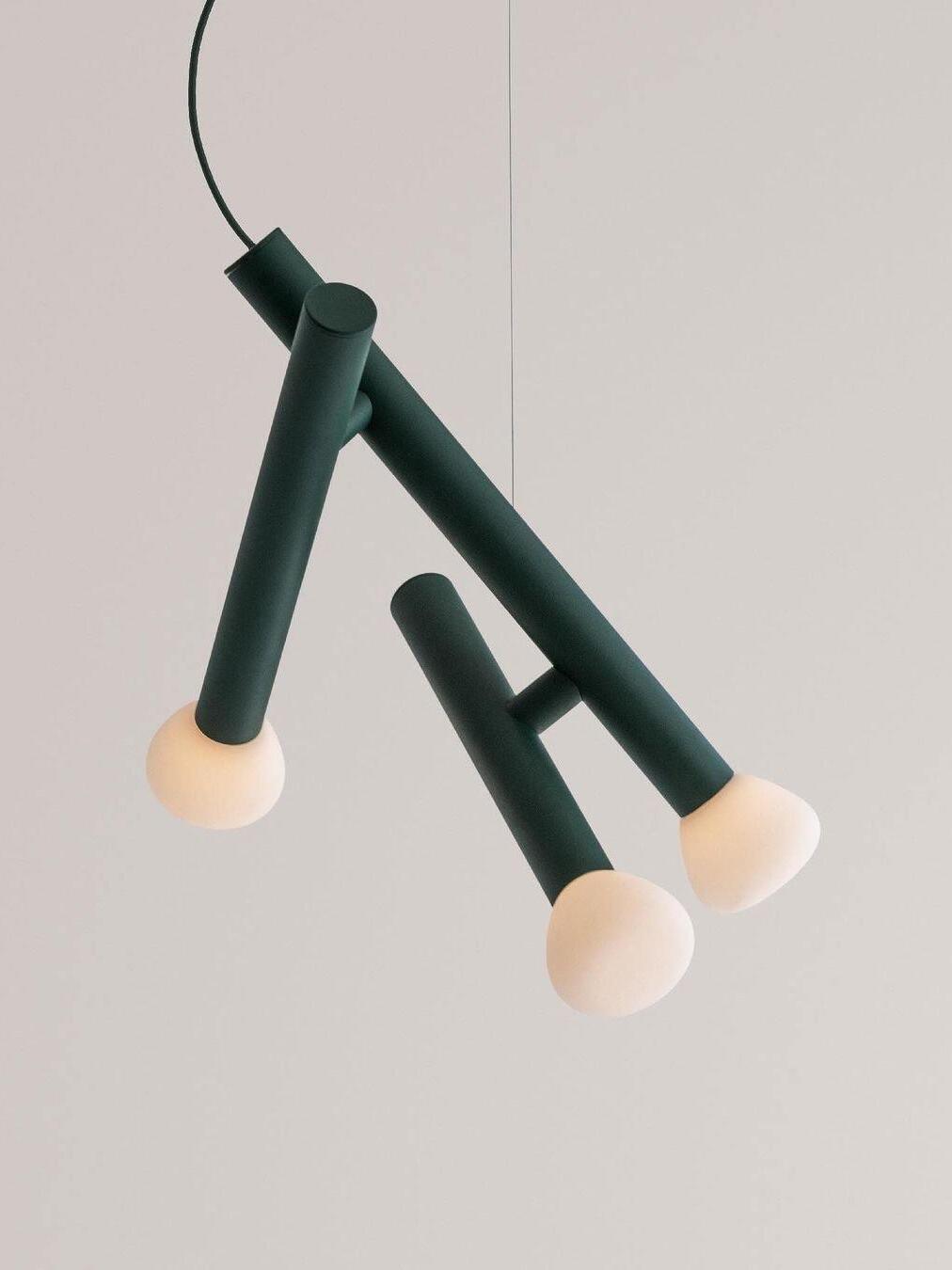 Green three-head pendant with a loose power cord and fine suspension wire