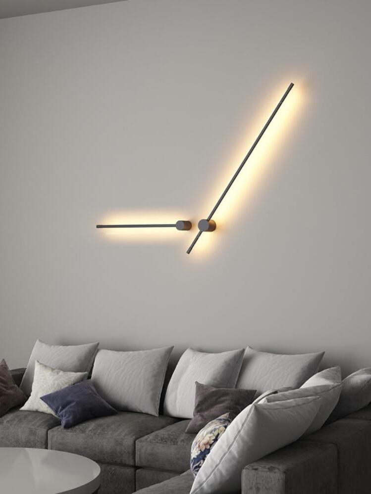 Two angled linear lights above a grey sofa