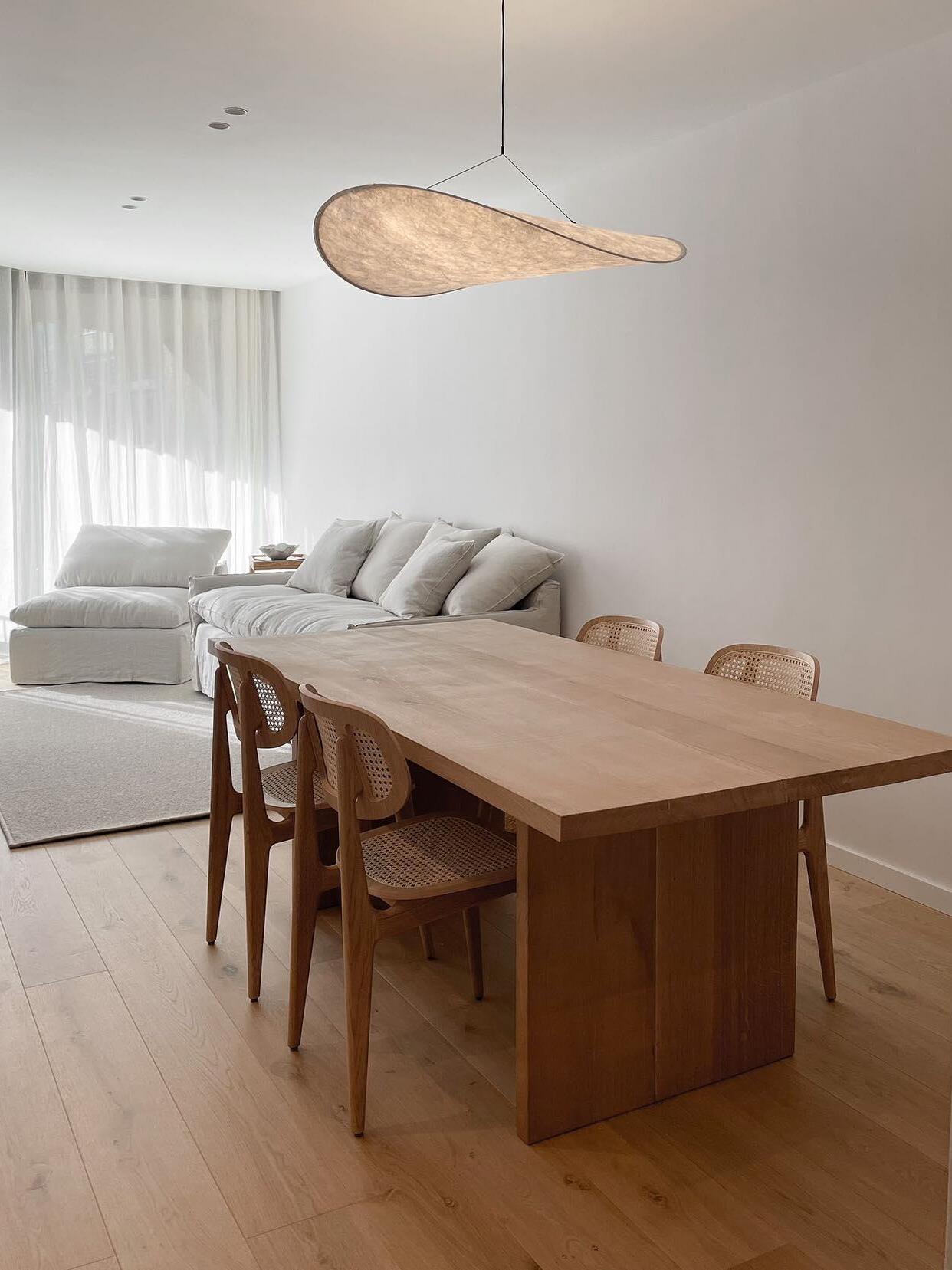 Cloud-like pendant over a wood dining table