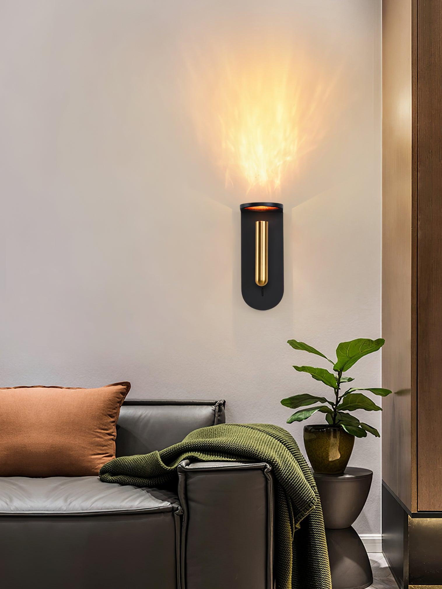 Illuminated black Nights wall light above a green chair beside a leafy plant