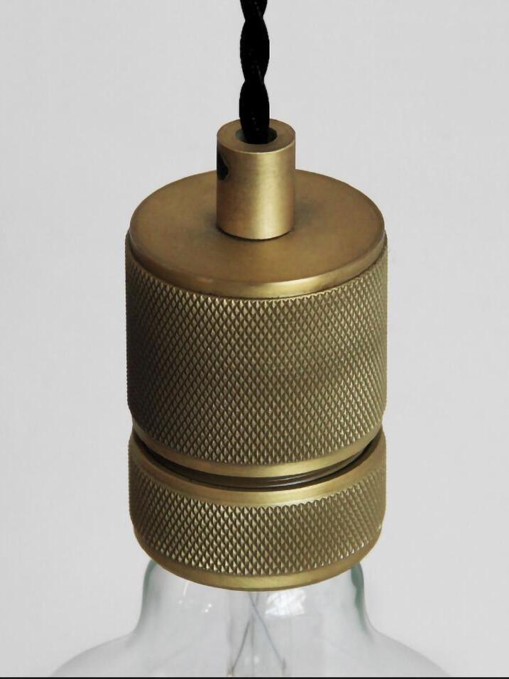 Close textured cylindrical bulb holder with twisted black cable
