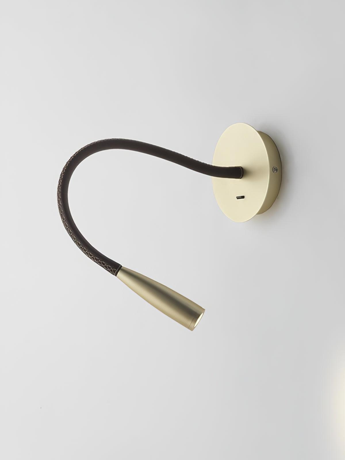 Pale gold-toned Flexi with a dark stitched-looking curved arm extended outward and a lit tapered head