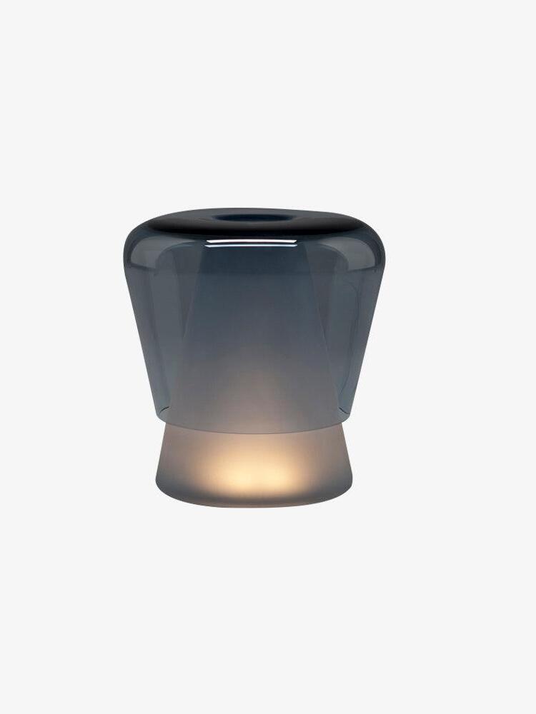 Blue rounded glass Jumelle lamp on pale background