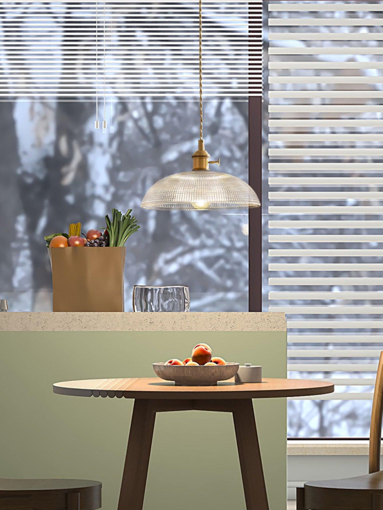 Textured glass pendant above dining table by window