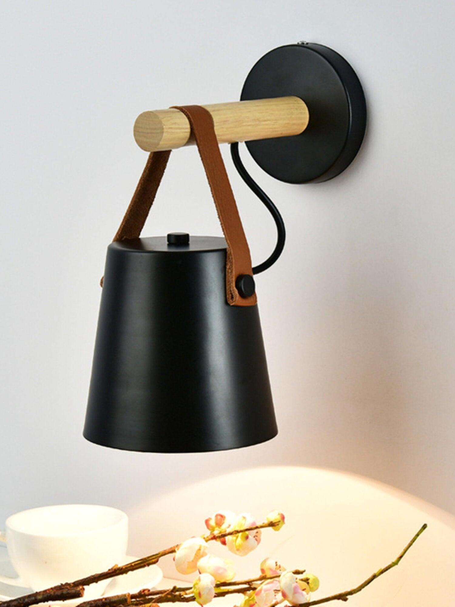 Black hanging shade over a small tabletop arrangement