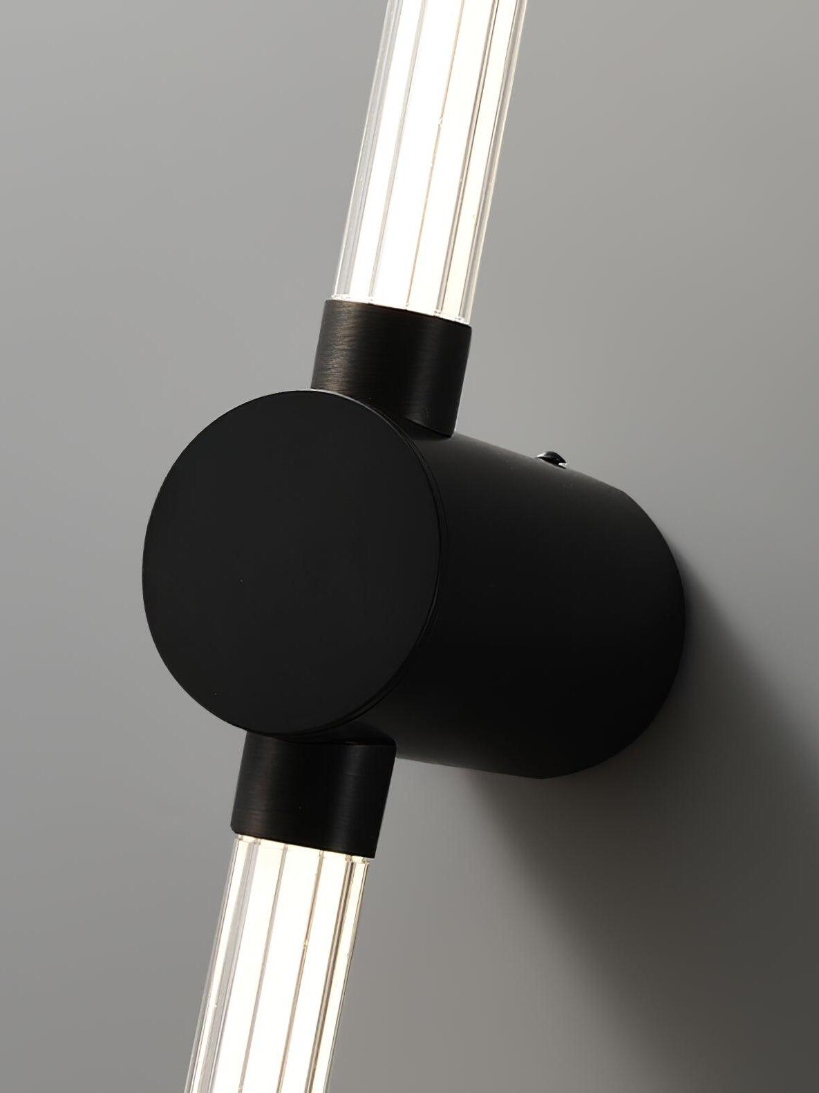 Close view of a round black mount and collars between clear ribbed luminous tube sections