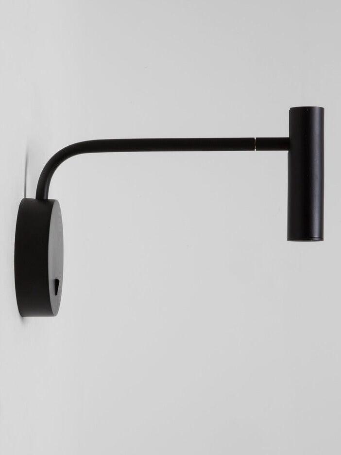 Side view of black L-arm sconce and round plate